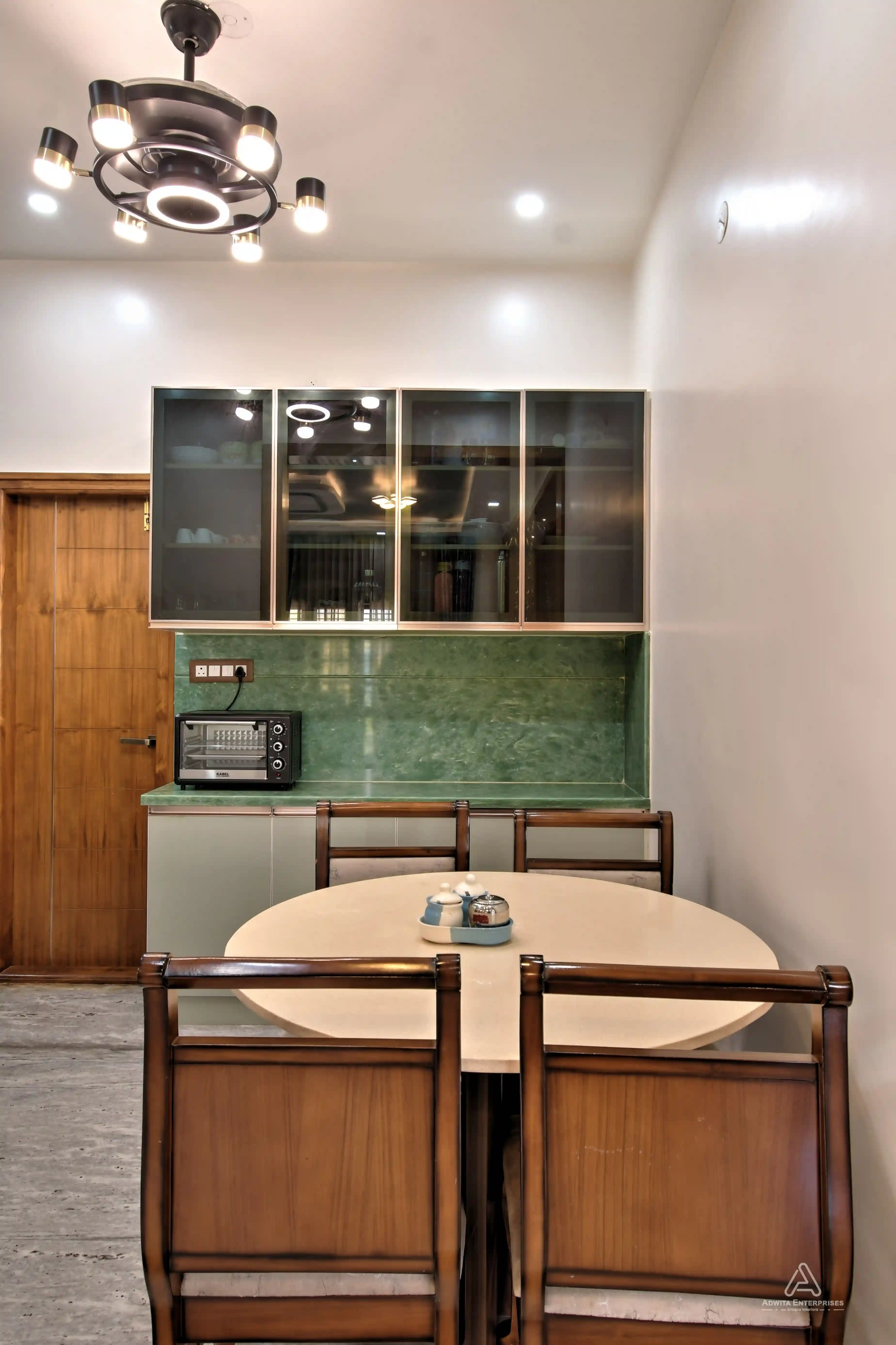 Modern kitchen with neat cabinets, smart storage, crockery, and dining table