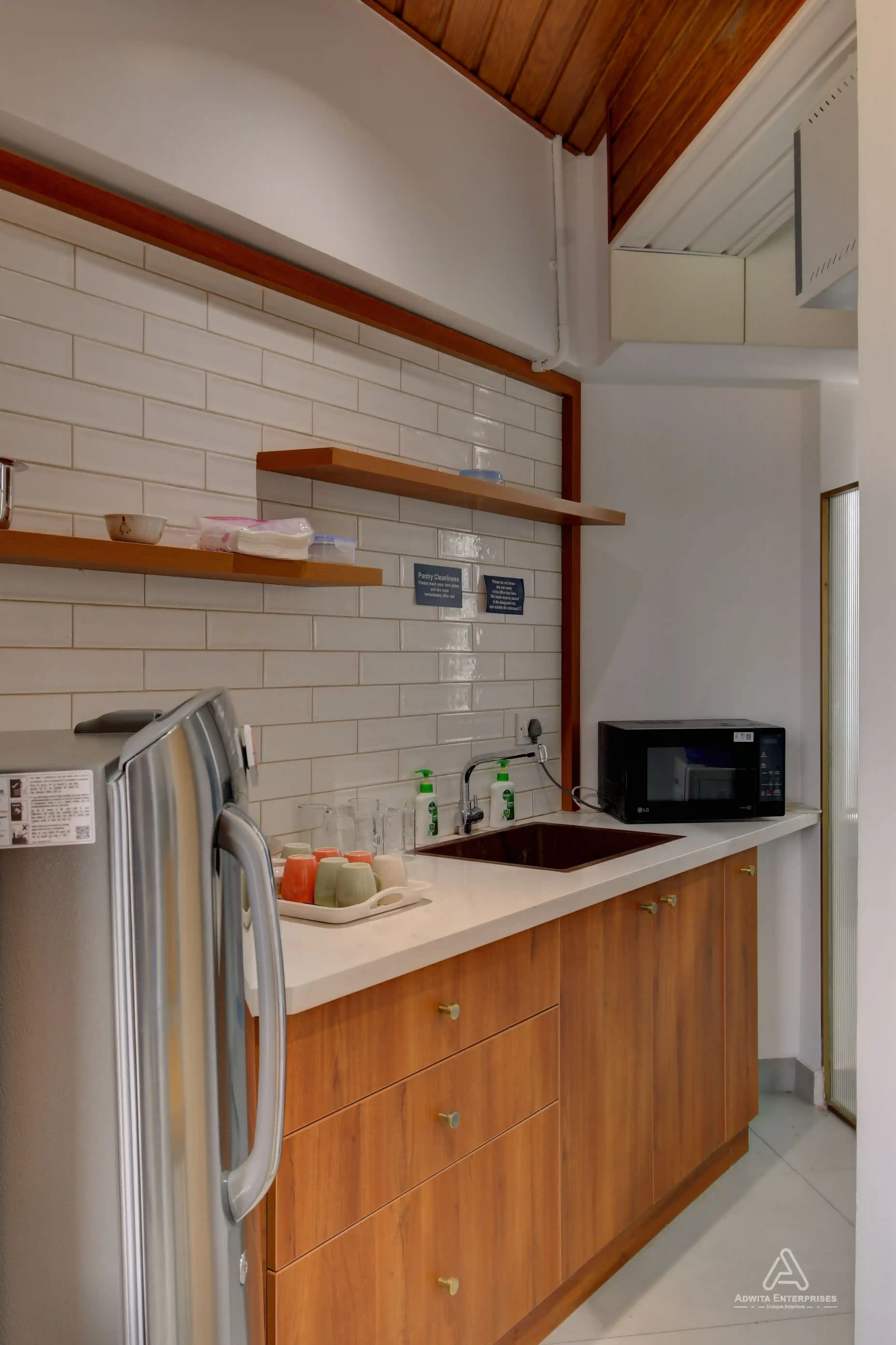 Pantry area with sleek cabinets, countertop, and modern appliances