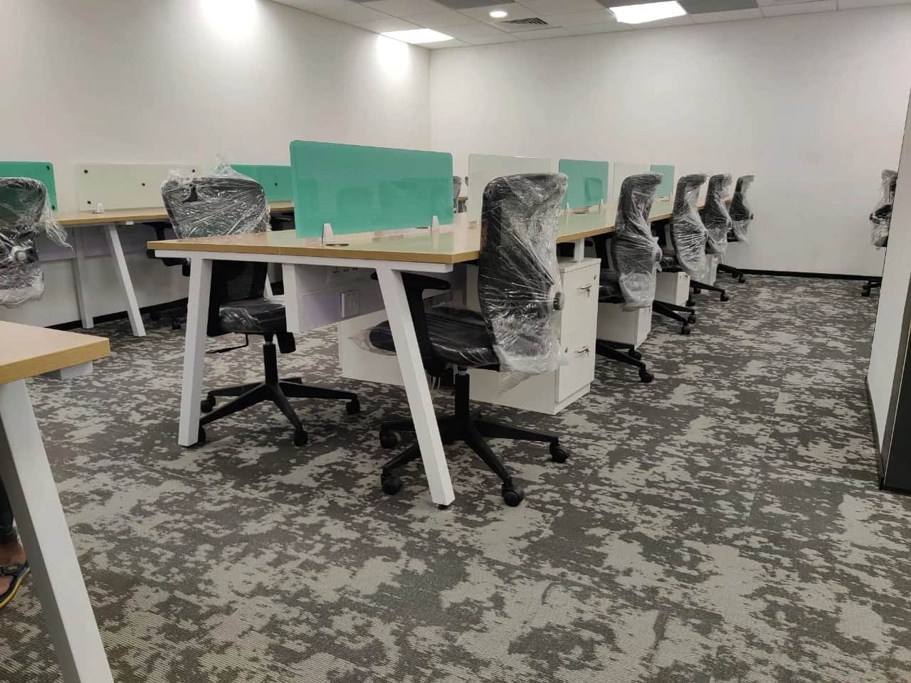Discussion room with large conference table, ergonomic chairs, and modern lighting