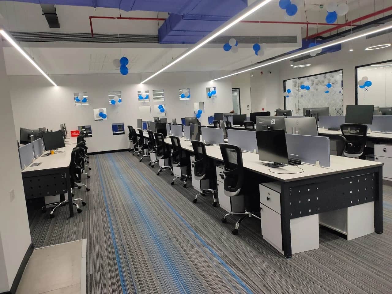 Discussion room with large conference table, ergonomic chairs, and modern lighting