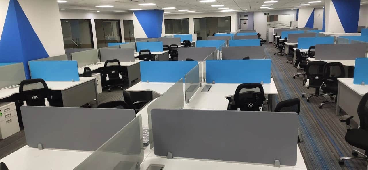 Discussion room with large conference table, ergonomic chairs, and modern lighting