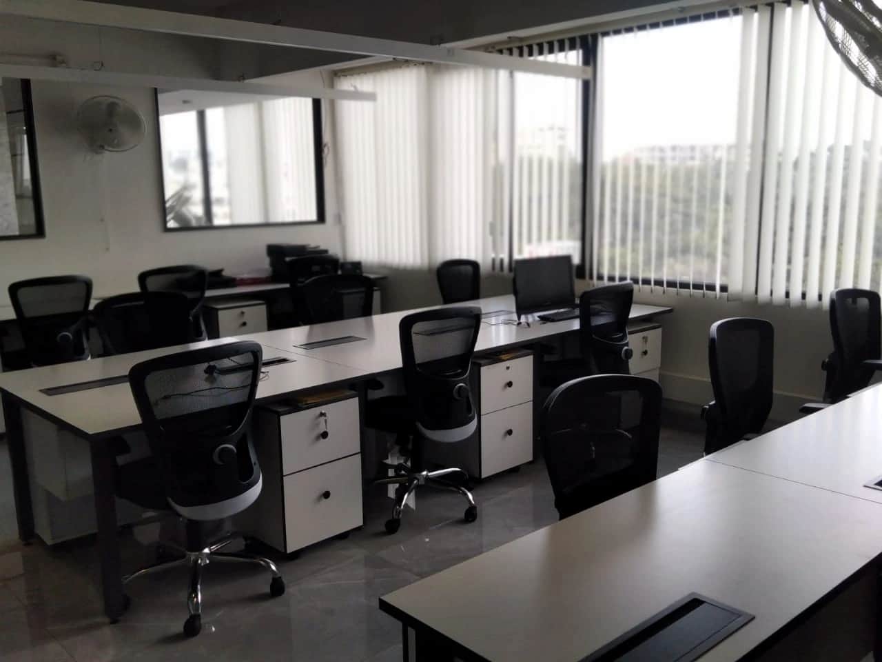 Discussion room with large conference table, ergonomic chairs, and modern lighting