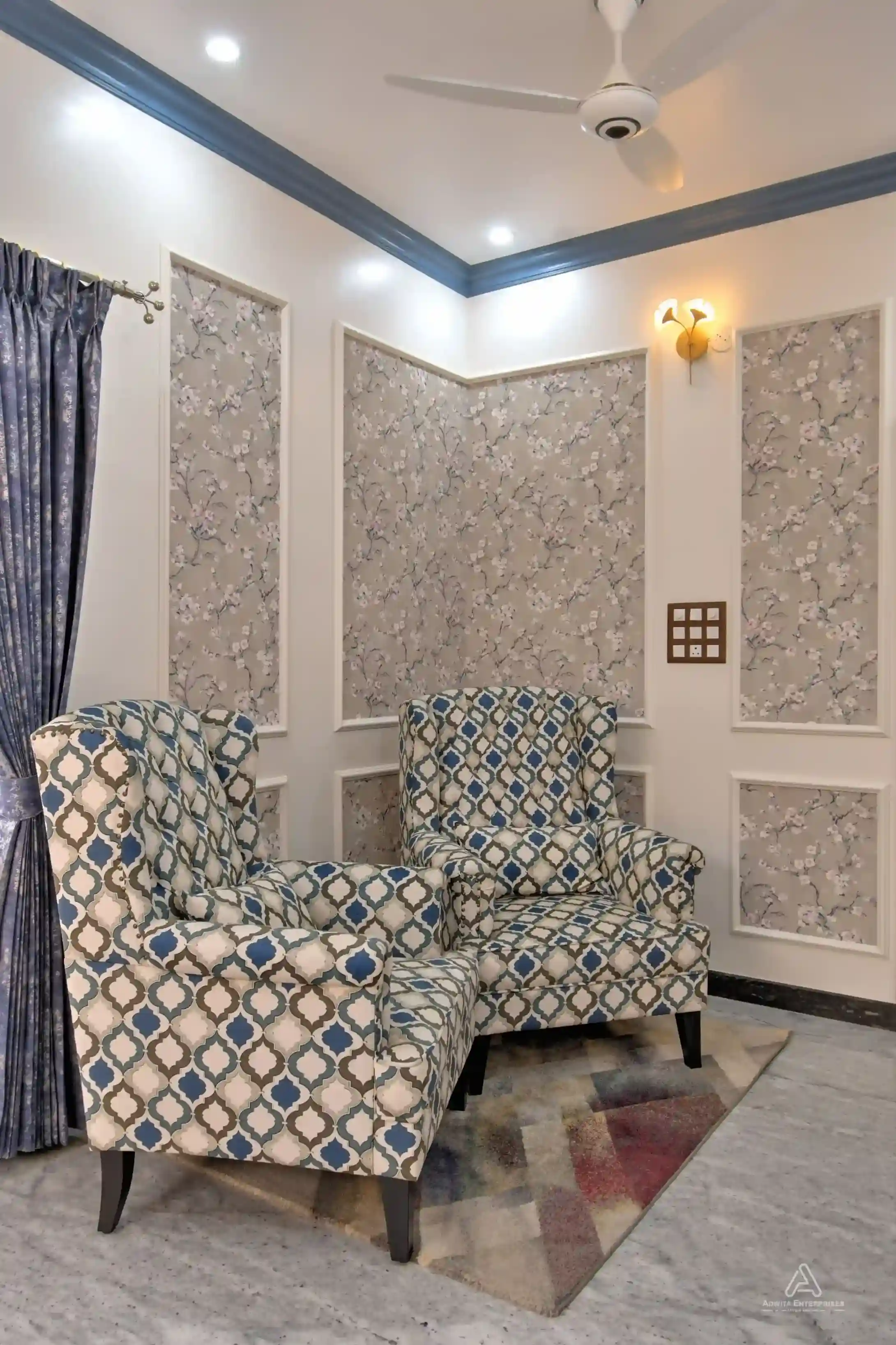 Modern living room featuring two single premium sofas and ambient lighting